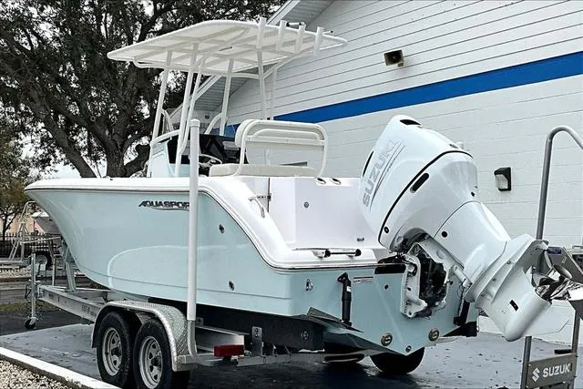 Slide: The Image of 2025 Aquasport 2200 Center Console boat on trailer, featuring Suzuki outboard motor. - 35