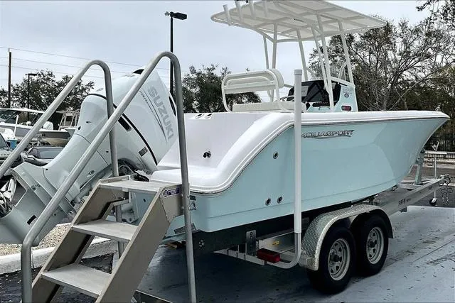 Slide: The Image of 2025 Aquasport 2200 Center Console boat on trailer with Suzuki outboard motor. - 37