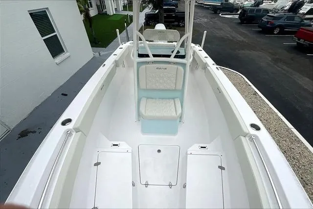 Slide: The Image of 2025 Aquasport 2200 Center Console boat, white interior, docked at marina. - 39
