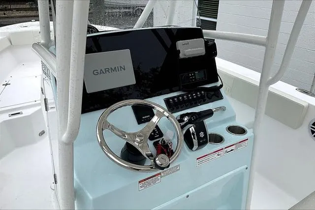 Slide: The Image of 2025 Aquasport 2200 Center Console boat dashboard with Garmin navigation system. - 41