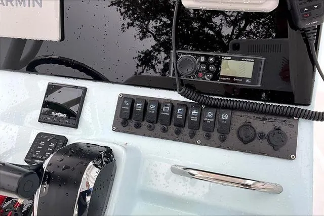 Slide: The Image of Control panel of 2025 Aquasport 2200 Center Console boat with electronic devices. - 45