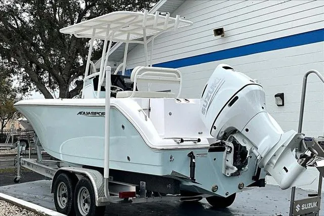 Slide: The Image of 2025 Aquasport 2200 Center Console boat on trailer with Suzuki outboard motor. - 5