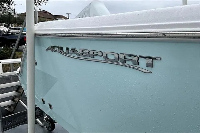 Slide: The Image of 2025 Aquasport 2200 Center Console boat, side view with logo in focus. - 6