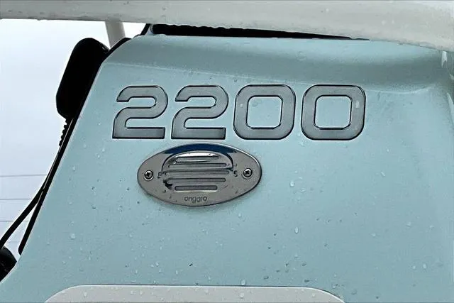 Slide: The Image of 2025 Aquasport 2200 Center Console boat detail with model number and speaker. - 7