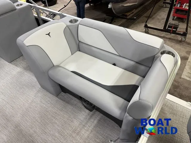 Slide: The Image of 2025 Tahoe Sport 23' Fish & Cruise boat seating, gray upholstery, cup holders, Boat World logo. - 10