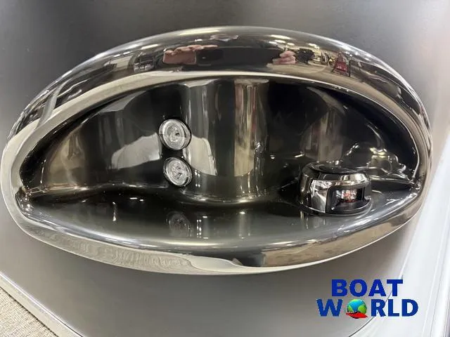 Slide: The Image of 2025 Tahoe Sport 23' Fish & Cruise boat detail with chrome accents, showcased at Boat World. - 37