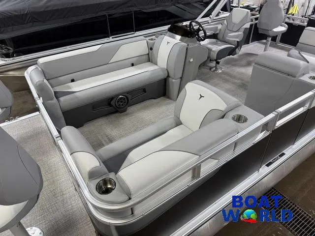 Slide: The Image of 2025 Tahoe Sport 23' Fish & Cruise boat interior with seating and steering console. - 4