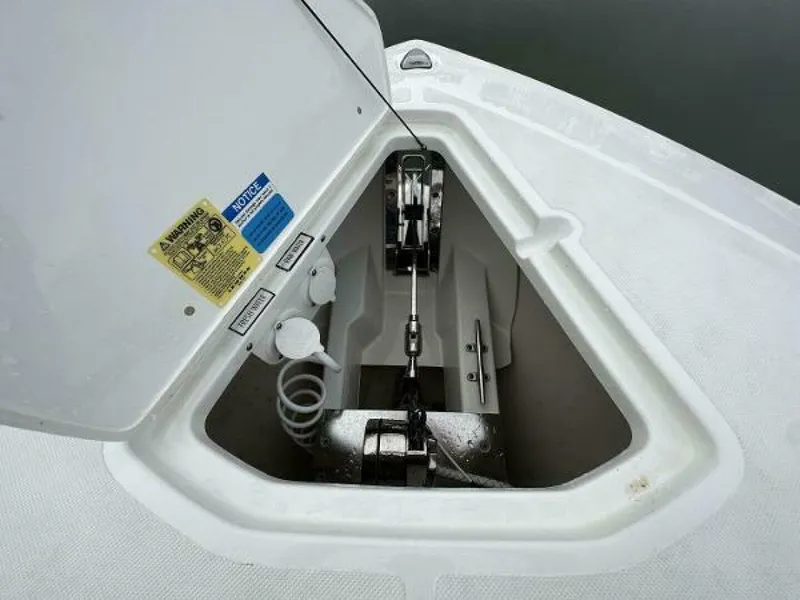 Slide: The Image of 2019 Pursuit DC 325 Dual Console anchor compartment with open hatch and visible anchor mechanism. - 5