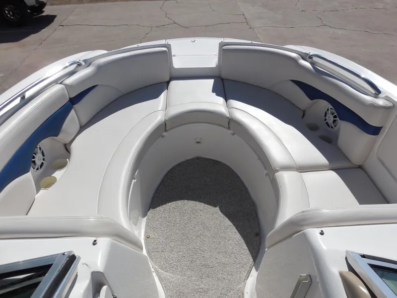 Slide: The Image of 2003 Chaparral Sunesta 243 boat interior with white seating and blue accents. - 10