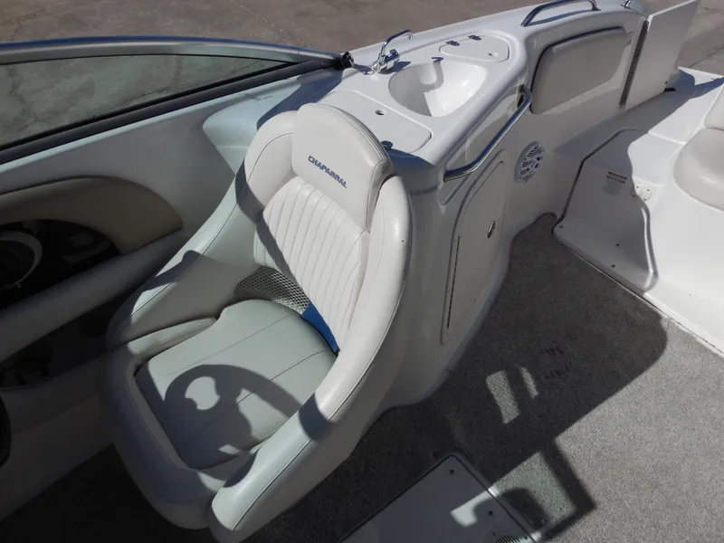 Slide: The Image of 2003 Chaparral Sunesta 243 boat interior with white seating and console. - 12