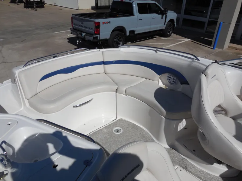 Slide: The Image of 2003 Chaparral Sunesta 243 boat interior with white seating and blue accents. - 13