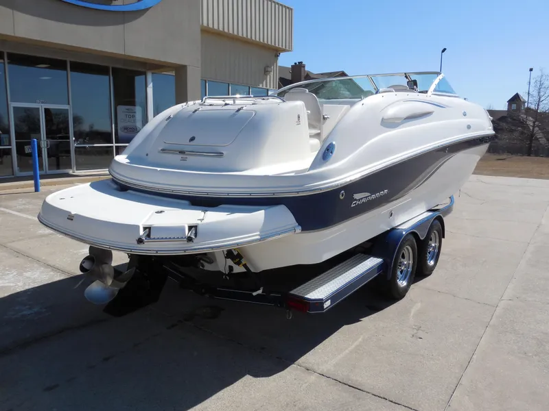 Slide: The Image of 2003 Chaparral Sunesta 243 boat on trailer, parked outside a building. - 3
