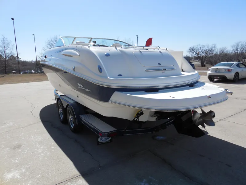Slide: The Image of 2003 Chaparral Sunesta 243 boat on trailer, parked outdoors on a sunny day. - 4