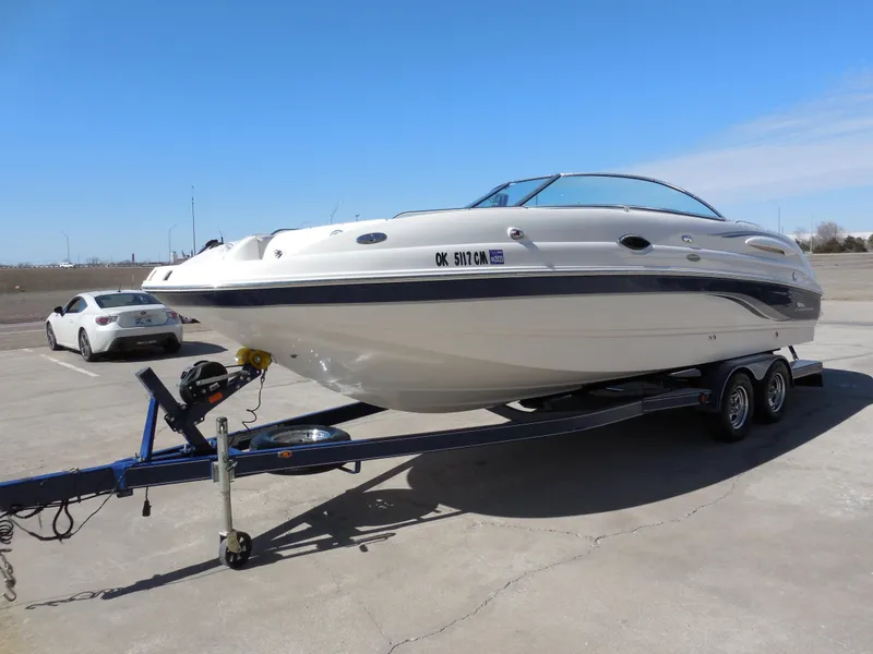 Slide: The Image of 2003 Chaparral Sunesta 243 boat on trailer in parking lot. - 6