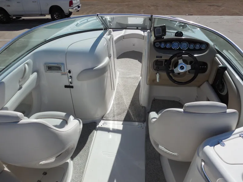 Slide: The Image of 2003 Chaparral Sunesta 243 boat interior with steering wheel and seating. - 8