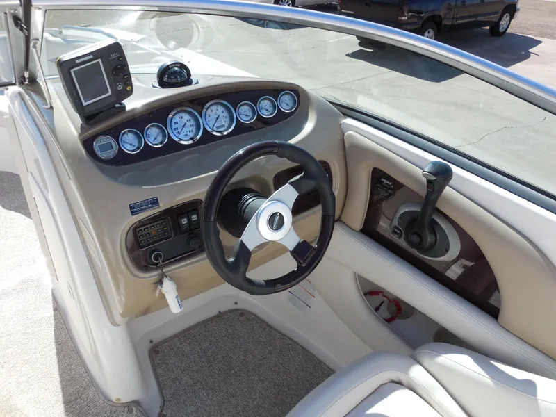 Slide: The Image of 2003 Chaparral Sunesta 243 boat dashboard with steering wheel and gauges. - 9