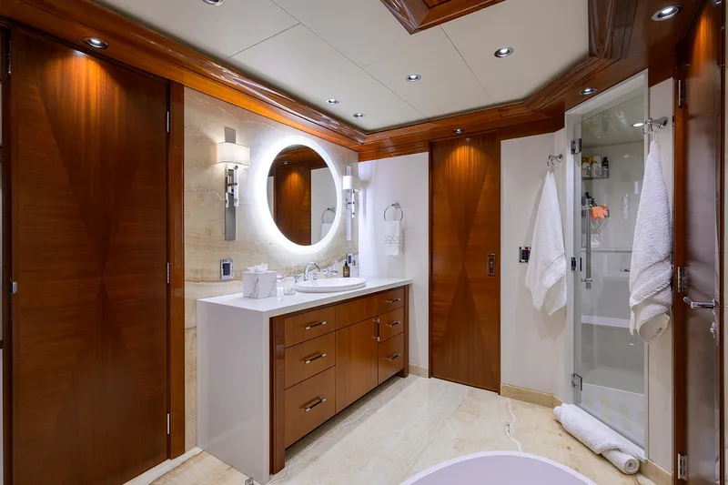 Slide: The Image of Luxurious bathroom in 2020 Westport Motor Yacht with elegant wood finishes and modern fixtures. - 15