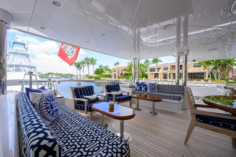 Slide: The Image of Luxurious 2020 Westport Motor Yacht deck with elegant seating and scenic waterfront view. - 2