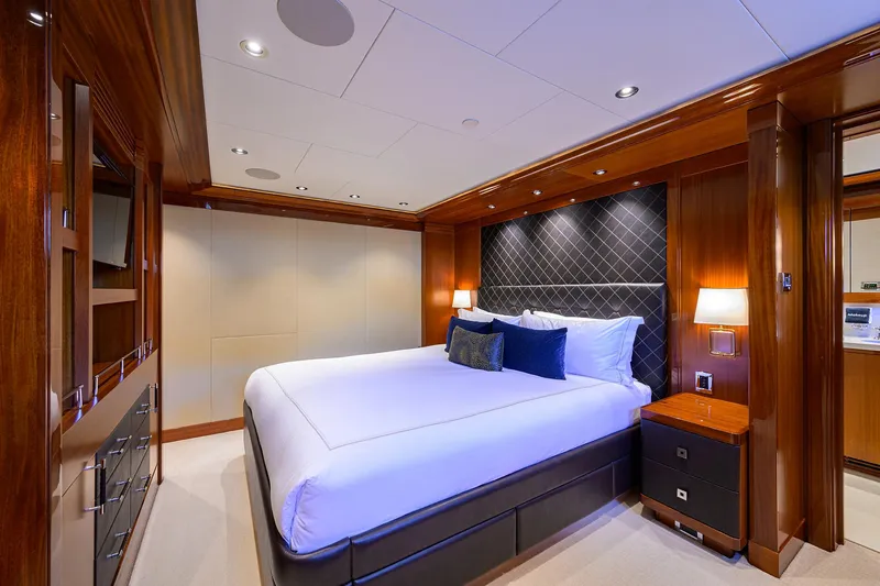 Slide: The Image of Luxurious bedroom interior in 2020 Westport Motor Yacht, featuring elegant wood finishes and modern lighting. - 20