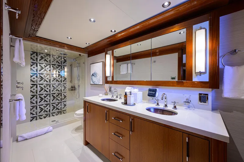 Slide: The Image of Luxurious bathroom in 2020 Westport Motor Yacht with dual sinks and elegant shower design. - 21