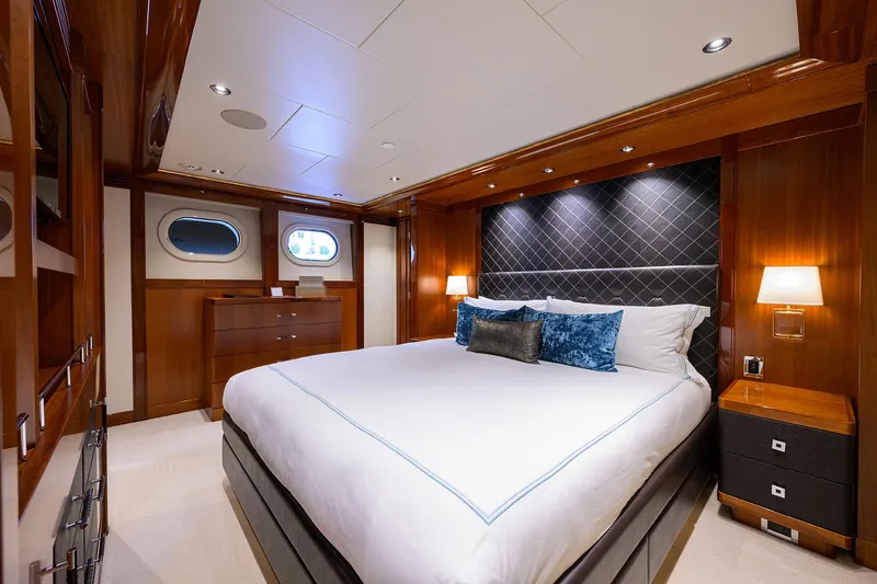 Slide: The Image of Luxurious bedroom in 2020 Westport Motor Yacht with elegant wood paneling and modern lighting. - 22