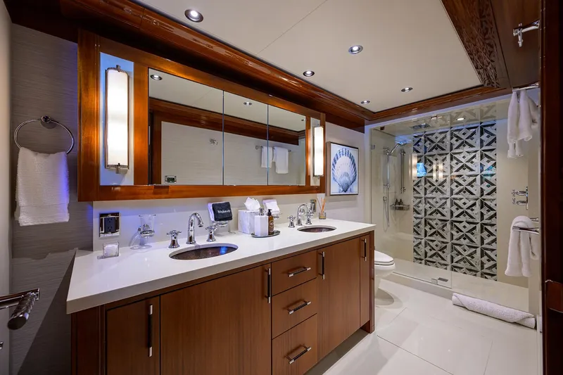 Slide: The Image of Luxurious bathroom in 2020 Westport Motor Yacht with elegant wood cabinetry and modern fixtures. - 23