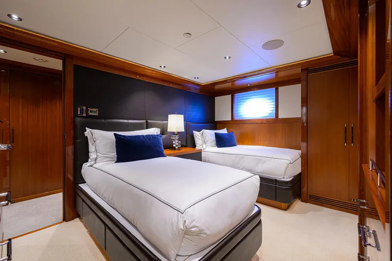 Slide: The Image of Luxurious twin bedroom in 2020 Westport Motor Yacht with elegant wood finishes and modern lighting. - 24