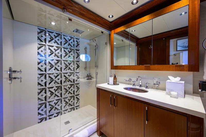 Slide: The Image of Luxurious bathroom in 2020 Westport Motor Yacht with modern shower and elegant wood cabinetry. - 27