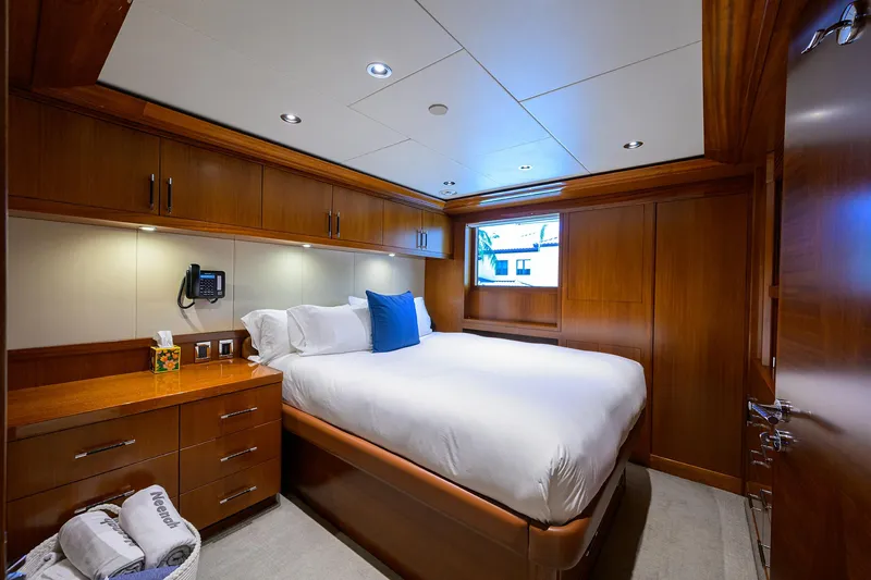 Slide: The Image of Luxurious cabin interior of 2020 Westport Motor Yacht with wooden furnishings and cozy bedding. - 31