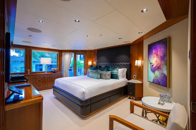 Slide: The Image of Luxurious bedroom interior on 2020 Westport Motor Yacht with modern decor and vibrant artwork. - 34