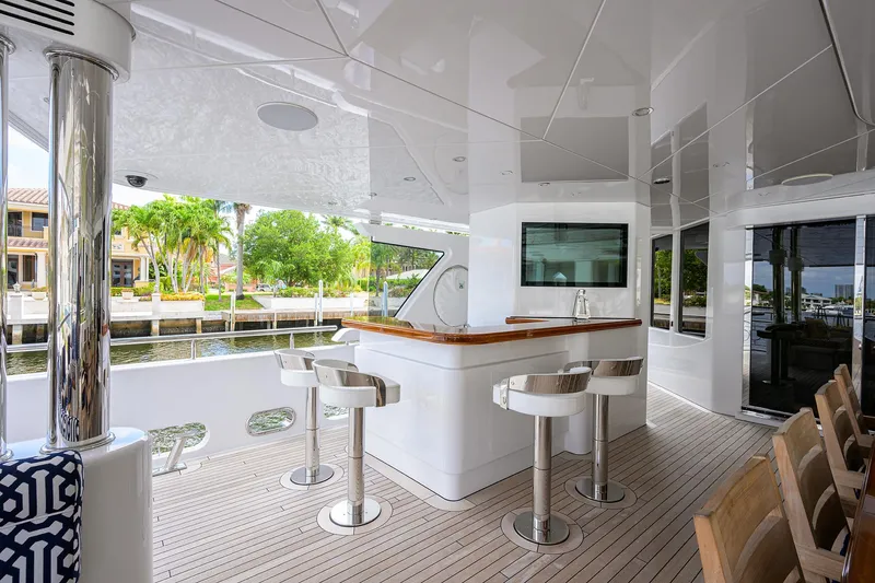 Slide: The Image of Luxurious 2020 Westport Motor Yacht with elegant outdoor bar and seating area. - 4