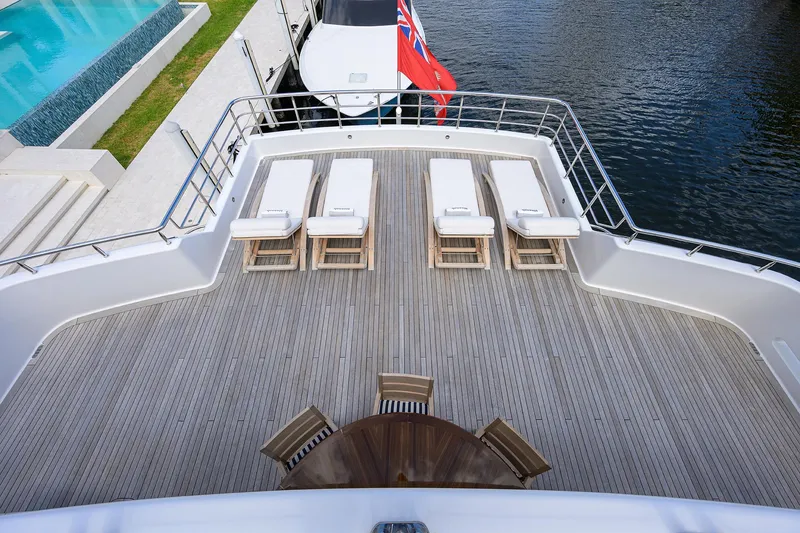 Slide: The Image of Luxurious 2020 Westport Motor Yacht deck with sun loungers and waterfront view. - 40