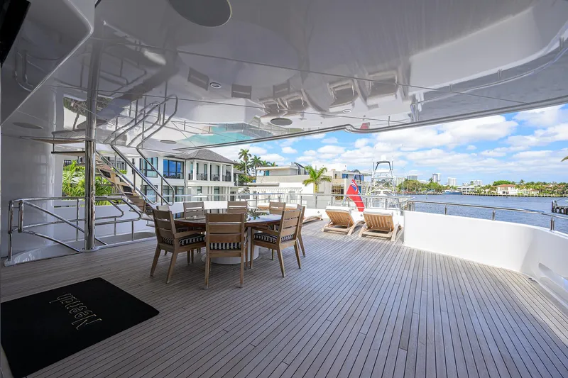Slide: The Image of Luxurious 2020 Westport Motor Yacht deck with dining area and waterfront view. - 42