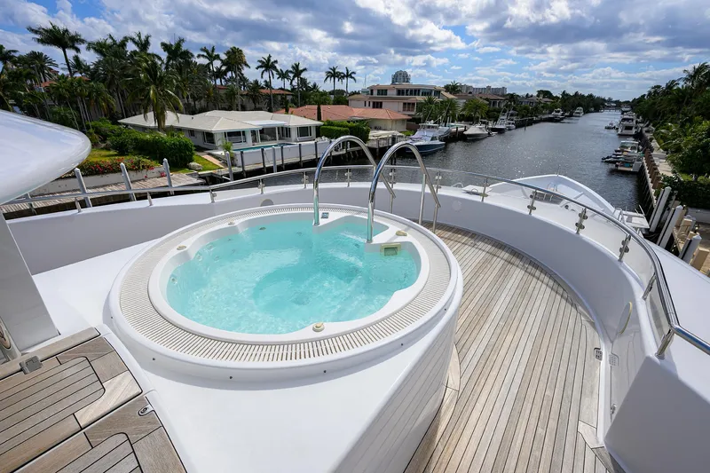 Slide: The Image of Luxurious 2020 Westport Motor Yacht with jacuzzi on deck, overlooking scenic waterfront. - 45