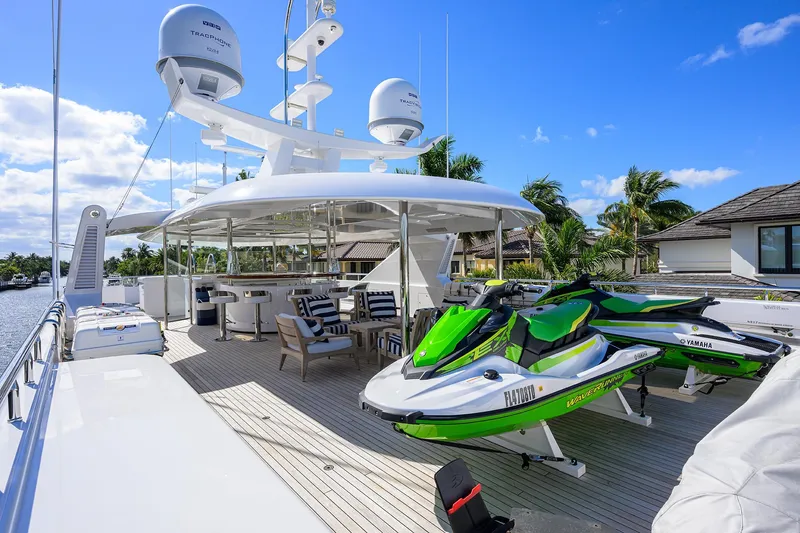 Slide: The Image of Luxurious 2020 Westport Motor Yacht deck with jet skis and outdoor seating. - 46