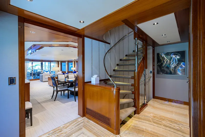 Slide: The Image of Luxurious interior of 2020 Westport Motor Yacht with elegant staircase and dining area. - 9