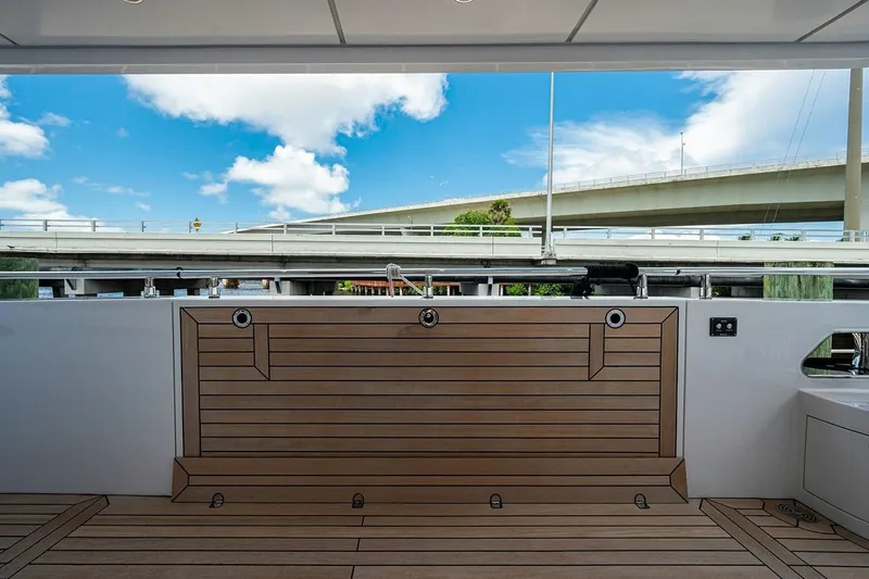 Slide: The Image of 2020 Majesty motor yacht deck with wooden flooring and scenic bridge view. - 4