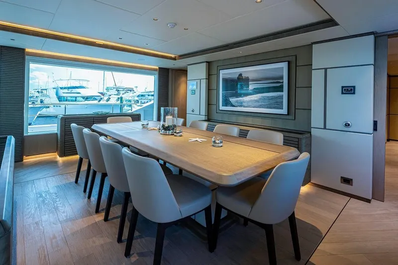 Slide: The Image of Luxurious dining area on a 2020 Majesty motor yacht with elegant decor and marina view. - 8
