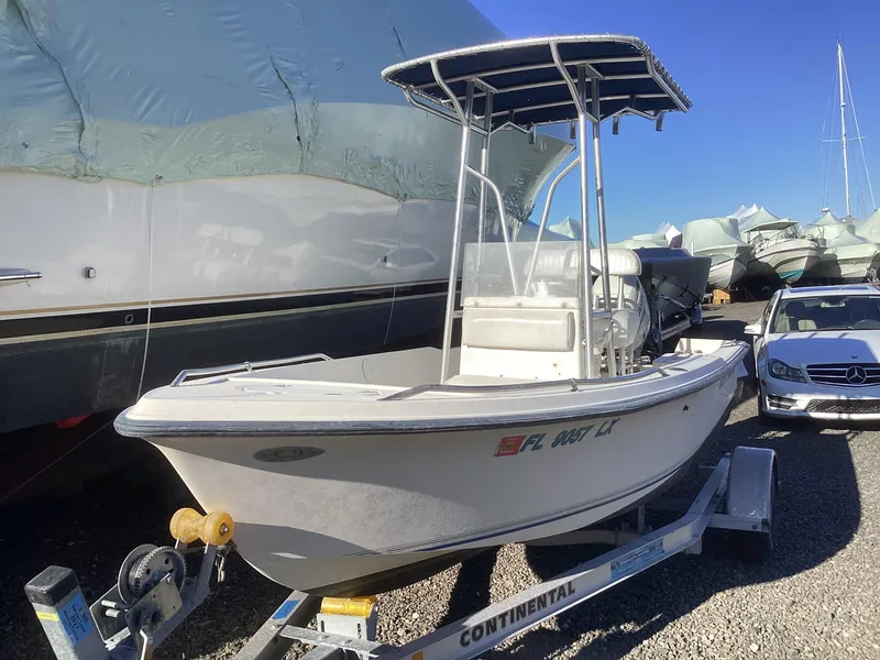 Slide: The Image of 2002 Key West 1720 boat on trailer, parked outdoors in a marina. - 1