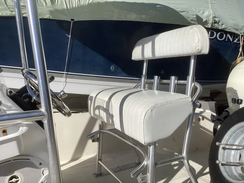 Slide: The Image of 2002 Key West 1720 boat interior with white cushioned seat and steering wheel. - 4