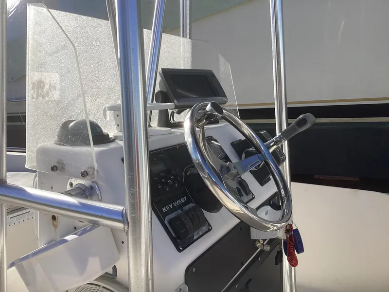 Slide: The Image of 2002 Key West 1720 boat console with steering wheel and navigation equipment. - 6