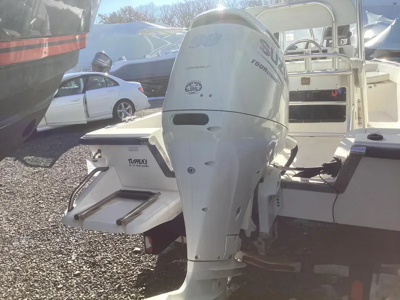 Slide: The Image of 2002 Key West 1720 boat with Suzuki outboard motor in a parking area. - 8