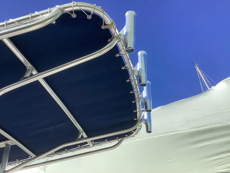 Slide: The Image of Key West 1720 boat canopy and rod holders against clear blue sky, 2002 model. - 9