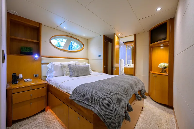 Slide: The Image of Luxurious 2008 Lazzara Motor Yacht bedroom with elegant wood furnishings and cozy bedding. - 23