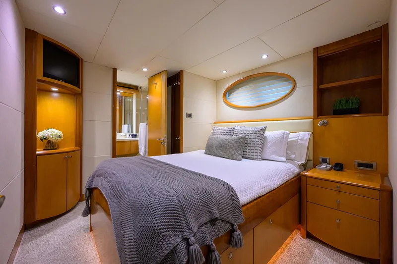 Slide: The Image of Luxurious 2008 Lazzara Motor Yacht bedroom with elegant wood finishes and cozy bedding. - 26