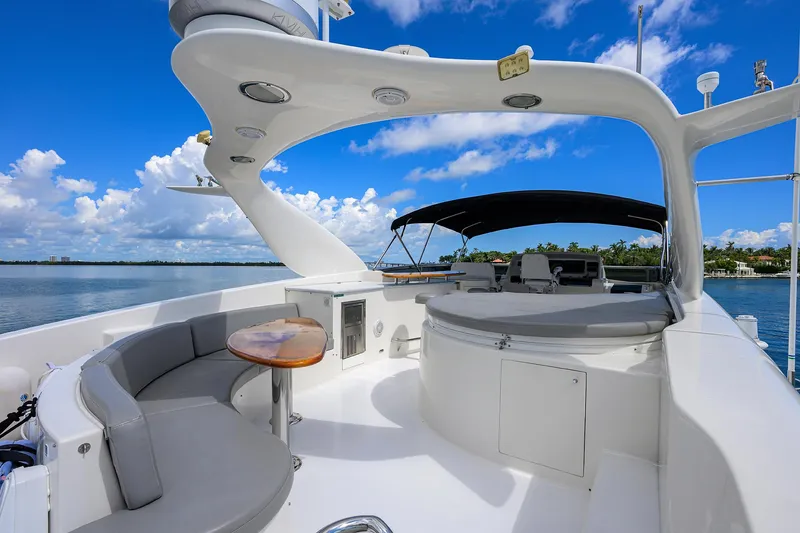 Slide: The Image of 2008 Lazzara Motor Yacht deck with seating, table, and canopy under a clear blue sky. - 38