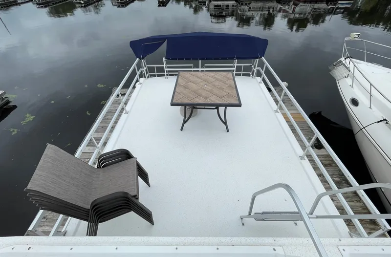 Slide: The Image of Upper deck of 2003 Gibson 50 Classic boat with chairs and table. - 10