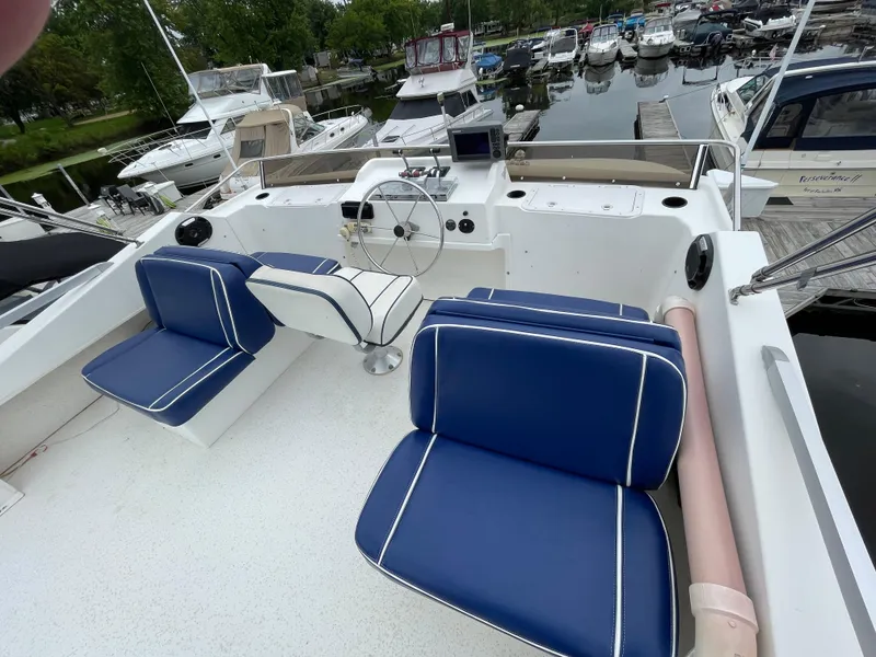 Slide: The Image of 2003 Gibson 50 Classic boat interior with blue seating at marina. - 17