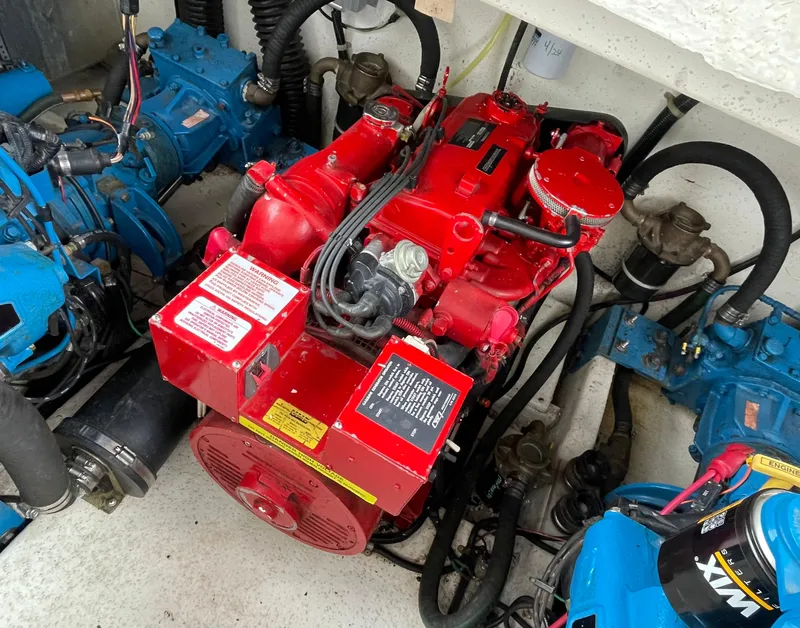 Slide: The Image of Red engine in a 2003 Gibson 50 Classic boat, surrounded by blue components. - 19