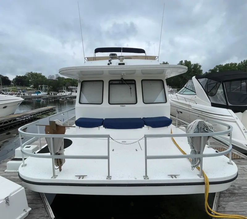 Slide: The Image of 2003 Gibson 50 Classic boat docked at marina, featuring spacious deck and seating. - 2